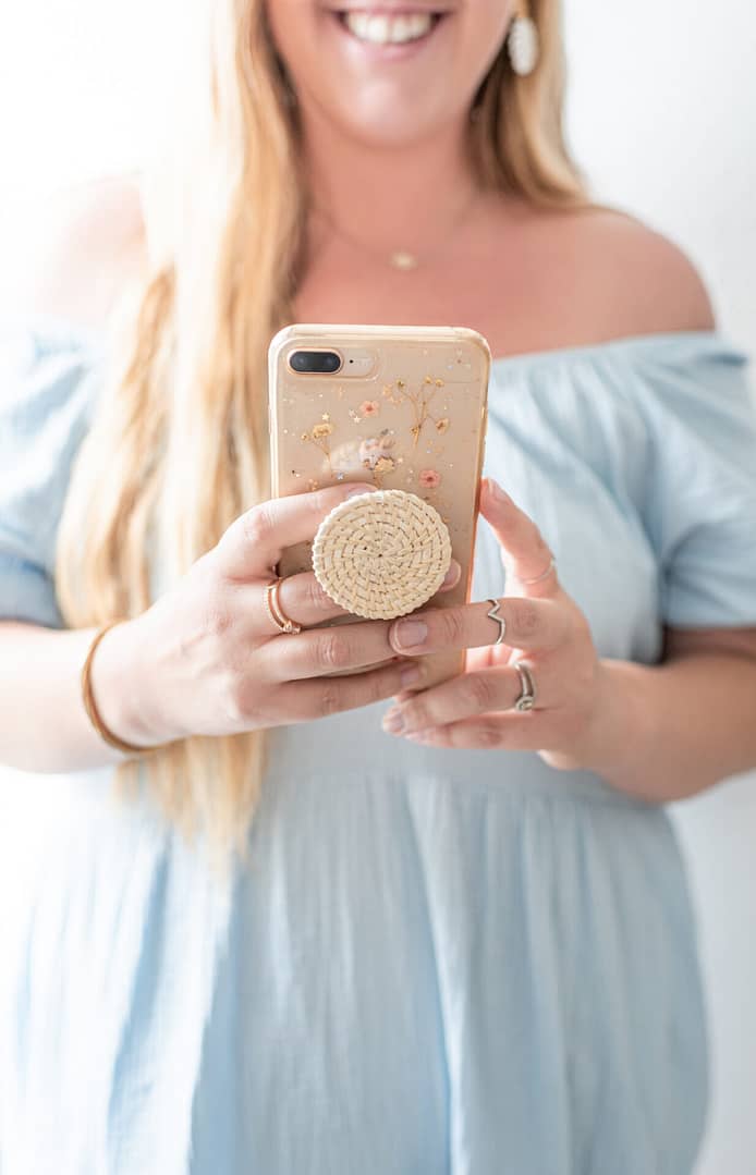 woman looking at her phone and smiling