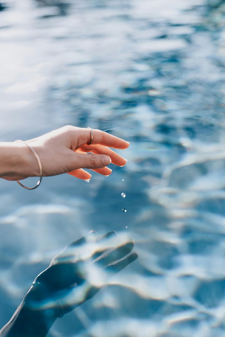 woman dipping her hand in water