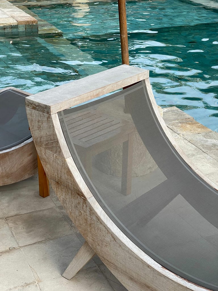 a chair next to a pool